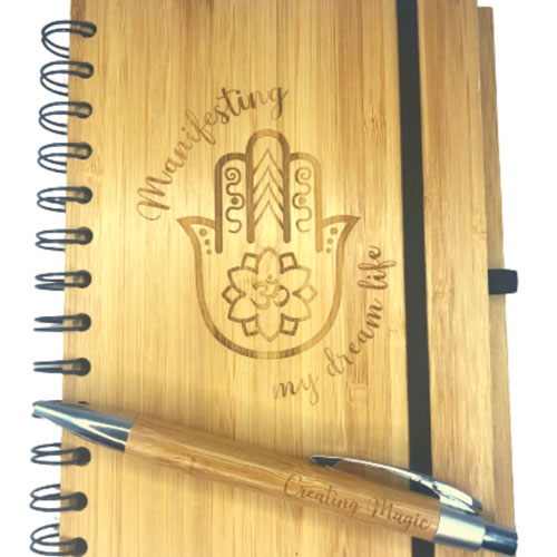 close up of hand of fatima on a personalised bamboo notebook and pen