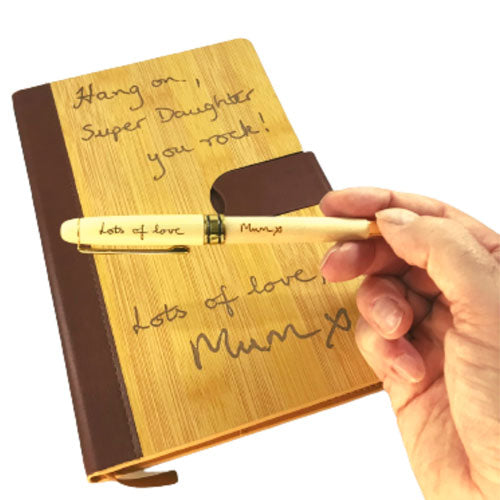 a loved ones handwriting engraved onto our personalised notebook and optional wood pen