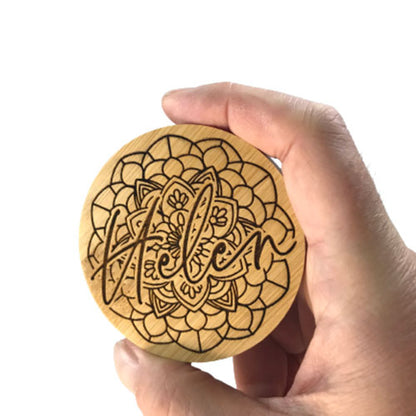 holding a personalised bamboo mirror to show size