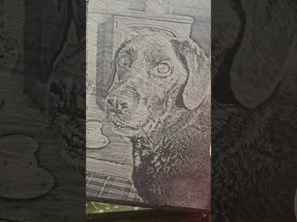 taking the customer photo of their pet and engraving onto slate as a memorial